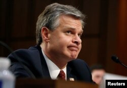 FILE - Director of the Federal Bureau of Investigation Christopher Wray testifies before a Senate Judiciary Committee hearing.