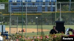 FILE - Police investigate a shooting scene after a gunman opened fire on Republican members of Congress during a baseball practice near Washington in Alexandria, Virginia, June 14, 2017. 