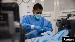 U.S. Army Specialist Fredrick Spencer assembles a T1 Hamilton ventilator in a mobile lab unit in the Javits New York Medical Station intensive care unit bay monitoring coronavirus disease (COVID-19) patients in New York City, U.S. Apri 4, 2020. Picture ta