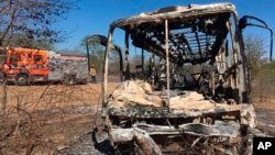 FILE: A fire engine is parked near a burnt out bus after a fatal bus accident in Gwanda, south of the capital Harare, Zimbabwe, that killed more than 40 people, Nov. 16, 2018. 