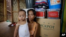 Cô Emily Sagalis và bé Bea Joy, những người sống sót sau trận bão Haiyan, trong ngôi nhà của họ ở Tacloban, 5/11/2014.