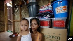 Typhoon survivor Emily Sagalis poses with baby Bea Joy inside her modest home near the Philippines’ coastal City of Tacloban, Nov.5, 2014. Bea Joy was named for her grandmother, Beatrice, who died in the storm.