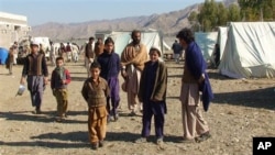 In this photo taken on Jan. 31, 2011, displaced Pakistanis arrived at a camp set up in Naghi, 18 kilometers northwest of the Afghanistan border in the Pakistani tribal area of Mohmand.