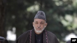 Afghan President Hamid Karzai arrives for a press conference, September 22, 2011, honoring former Afghan President Burhanuddin Rabbani who was killed two days ago in Kabul.