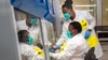 FILE — South African medical scientists prepare to sequence COVID-19 omicron samples at the Ndlovu Research Center in Elandsdoorn, on December 8, 2021. 