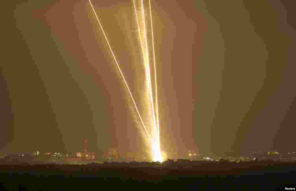 Light streaks and smoke trails are seen as rockets are launched from Gaza towards Israel, July 23, 2014.