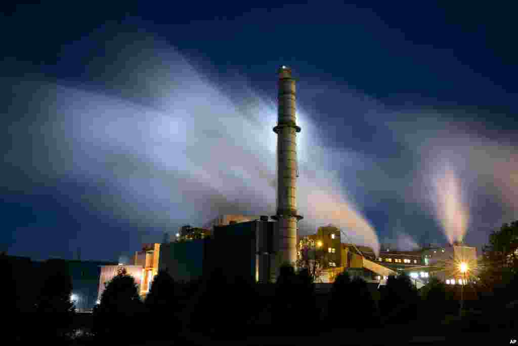 Steam from the Verso paper mill is backlit by the light of the setting moon in this time-exposure in Bucksport, Maine, USA, Sept. 20, 2013.