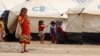 Displaced children, who fled from the Islamic State violence, gather at a refugee camp in the Makhmour area near Mosul, Iraq, June 17, 2016. 