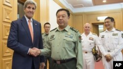 Last month U.S. Secretary of State John Kerry, left, met with Chinese Vice Chairman of the Central Military Commission General Fan Changlong. The general is returning to the U.S. for talks on a number of issues including building projects in the South China Sea. (Saul Loeb/Pool Photo via AP)