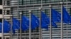 FILE - European Union flags are seen outside the European Commission headquarters in Brussels, Sept. 10, 2014. 