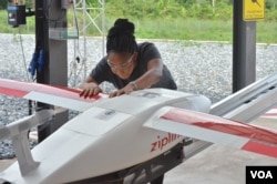 Zipline flight operator Josephine Fianu gets a drone ready for takeoff from the Omenako drone center. So far, four health centers are using the service in Ghana. (S. Knott/VOA)