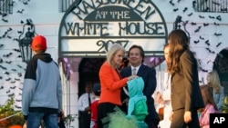 FILE - Counselor to the President Kellyanne Conway and her husband George Conway greet guests on the South Lawn of the White House during a Halloween event welcoming children to trick-or-treat, Oct. 30, 2017. 