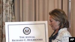 U.S. Secretary of State Hillary Clinton walks up to begin the Richard C. Holbrooke Lecture.