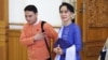 Aung San Suu Kyi walks with a NLD member into parliament in Naypyitaw, Myanmar, March 11, 2016. (Z. Aung/VOA News)