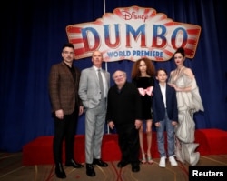 Cast members Colin Farrell, Michael Keaton, Danny DeVito, Nico Parker, Finley Hobbins and Eva Green pose at the premiere for the movie "Dumbo" in Los Angeles, California, March 11, 2019.