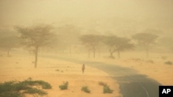 FILE - Through the 1980s, rainfall in the African Sahel declined more than anywhere else in the world, causing increased aridity, as evidenced by this dust storm in Senegal.