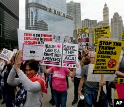 Protesters gather across the Chicago River from Trump Tower to rally against the repeal of the Affordable Care Act Friday, March 24, 2017, in Chicago.