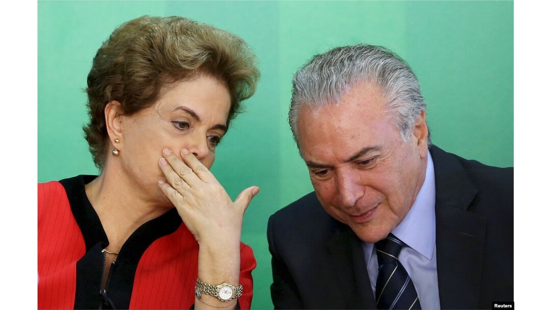 FILE - Brazil's President Dilma Rousseff (L) talks to Vice President Michel Temer at the Planalto Palace in Brasilia, Brazil, March 2, 2016.