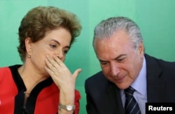 FILE - Brazil's President Dilma Rousseff (L) talks to Vice President Michel Temer at the Planalto Palace in Brasilia, Brazil, March 2, 2016.
