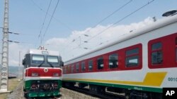 FILE - In this photo of Saturday, Sept.24, 2016, locomotives for the new Ethiopia to Djibouti electric railway system queue outside a train station in the outskirts of Addis Ababa. One of Africa's best-performing economies on Wednesday launched its latest massive infrastructure project, a railway linking the landlocked country with a major port on the Gulf of Aden. But it came just days after dozens were killed in anti-government protests in the region the railway runs through. 