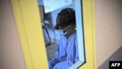 A patient with mental disorders sits in a living room at The Ville-Evrard Psychiatric Hospital in Saint-Denis, north of Paris on November 3, 2020. (Christophe ARCHAMBAULT / AFP)