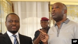 Ivory Coast President Laurent Gbagbo (R) speaks with Ivory Coast's Prime Minister Guillaume Soro before a meeting at the presidential palace in Yamoussoukro on February 18, 2010 after last week's surprise sacking of the cabinet by President Laurent Gbagbo