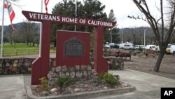 Media trucks set up at the entrance to the Veterans Home of California in Yountville, California, March 9, 2018.