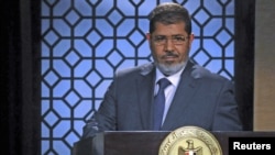 Egypt's President-elect Mohamed Morsi speaks during his first televised address to the nation at the Egyptian Television headquarters, Cairo June 24, 2012.