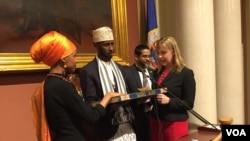 Ilhan Omar takes the Oath of Office on a special Koran in a ceremony at the Minnesota State Capitol Building, Jan. 3, 2017. (K. Farabaugh/VOA)