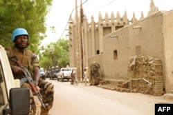 FILE - A peacekeeper with the United Nations patrols outside the mosque in Mopti, central Mali, May 30, 2018.