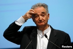 FILE - French economist Jacques Attali delivers a speech during a conference, Oct. 19, 2009.