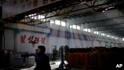 FILE - A North Korean factory worker walks through a processing hall at the Pyongyang 326 Electric Wire Factory pull Tuesday, Jan. 10, 2017, in Pyongyang, North Korea.