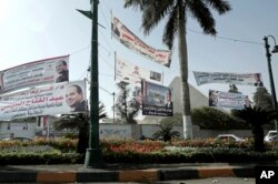 Election campaign banners for Egyptian presidential candidate President Abdel-Fattah el-Sissi hang in front of the Giza Pyramids, in Egypt, Monday, March 19, 2018.