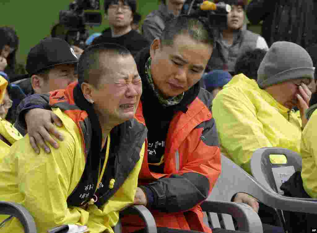 A relative of the victims weeps during a ceremony on the eve of the first anniversary of the ferry sinking at a port in Jindo, South Korea. More than 300 people, most of them school kids, were drowned in the disaster a year ago.