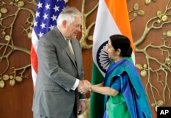 Indian Foreign Minister Sushma Swaraj, right, shakes hand with U.S. Secretary of State Rex Tillerson in New Delhi, India, Oct. 25, 2017.