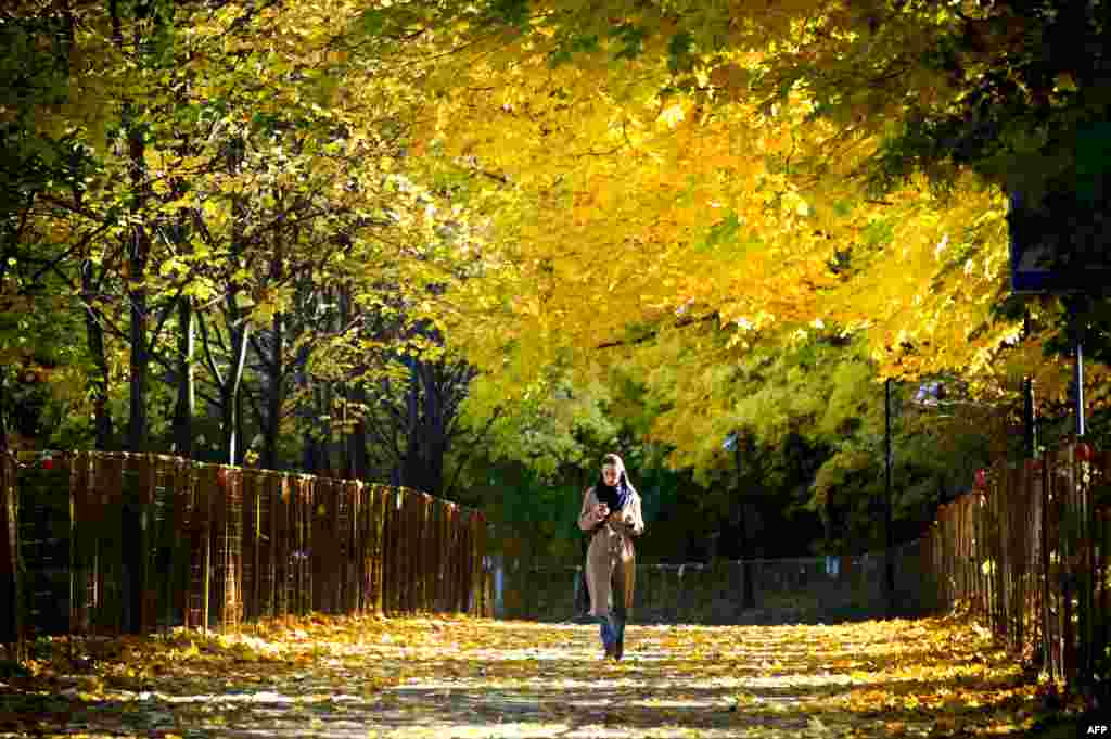 A woman walks in a park at Vorobyovy Hills in western Moscow, Russia.