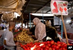 A vegetable vendor sells produce at a market in Cairo, Egypt, Jan. 10, 2017.