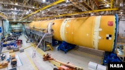 This August 2019 photo released by NASA, shows the core stage for NASA’s Space Launch System (SLS) rocket at the agency’s Michoud Assembly Facility in New Orleans. (Eric Bordelon/NASA via AP)