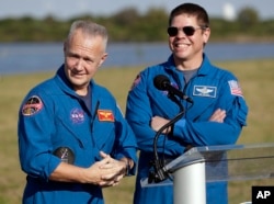 NASA astronauts Doug Hurley, left, and Bob Behnken answer questions during a news conference, March 1, 2019, before the Falcon 9 SpaceX Crew Demo-1 rocket launch at the Kennedy Space Center in Cape Canaveral, Fla. The astronauts are assigned to fly in the