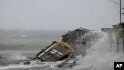 A house is engulfed by the storm surge brought about by powerful typhoon Haiyan that hit Legazpi city, Albay province, Nov. 8, 2013.