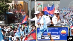 Opposition party Cambodia National Rescue Party (CNRP) President Kem Sokha greets his supporters from a truck as he leads a rally during the last day of campaigning ahead of communal elections in Phnom Penh, Cambodia, Friday, June 2, 2017. Cambodia's longtime ruler Hun Sen warned opposition parties Friday not to challenge the result of Sunday's local elections or they could be dissolved. (AP Photo/Heng Sinith)