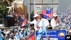 Opposition party Cambodia National Rescue Party (CNRP) President Kem Sokha greets his supporters from a truck as he leads a rally during the last day of campaigning ahead of communal elections in Phnom Penh, Cambodia, Friday, June 2, 2017.