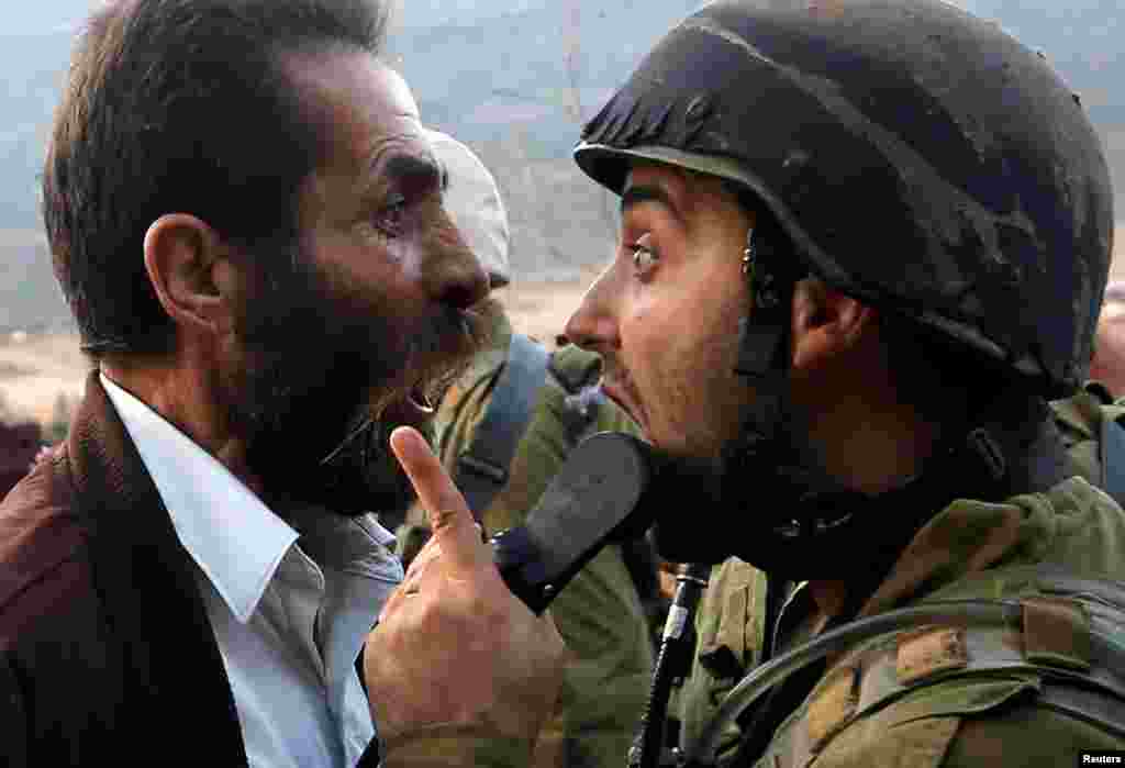 A Palestinian man argues with an Israeli soldier during clashes over an Israeli order to shut down a Palestinian school near Nablus in the occupied West Bank.