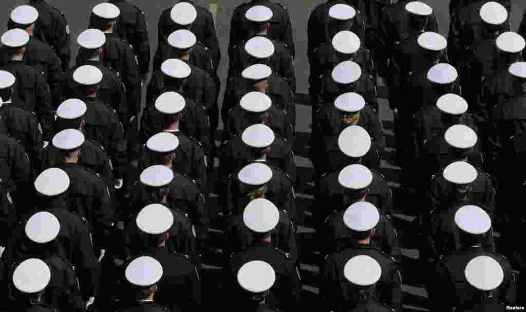 New French police officers stand at attention during a ceremony at the Police Prefecture in Paris, France.