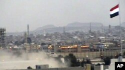 In this image taken from TV, showing Yemeni army helicopter emerging from the dust as it airlifts U.S. and other ambassadors out of a besieged embassy in Sanaa, Yemen, to the Presidential Palace to witness ruling party leaders signing an agreement for the