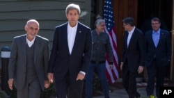 Secretary of State John Kerry walks with Afghanistan's President Ashraf Ghani before the start of a meeting at the Camp David Presidential retreat, March 23, 2015, in Camp David, Maryland.