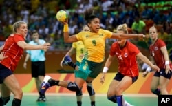 Brazil's Ana Paula Belo, center, scores a goal past Norway's Marit Malm Frafjord, right, during the women's preliminary handball match between Norway and Brazil at the 2016 Summer Olympics in Rio de Janeiro, Brazil, Aug. 6, 2016.