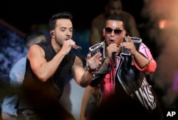FILE - Singers Luis Fonsi, left and Daddy Yankee perform during the Latin Billboard Awards in Coral Gables, Florida, April 27, 2017.