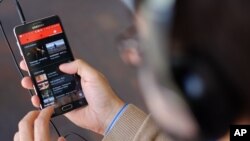 FILE - The YouTube Music app is displayed on a mobile phone in Los Angeles, Nov. 13, 2015.