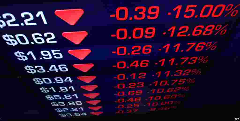 August 5: Display boards at the Australian Stock Exchange flicker with news of a falling market in Sydney. (AP Photo/Rick Rycroft)